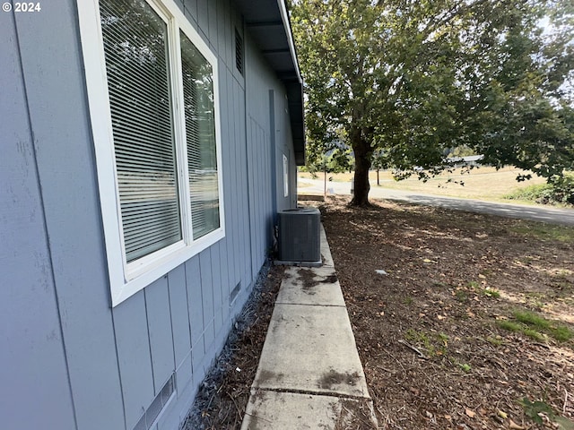 view of side of home with central AC