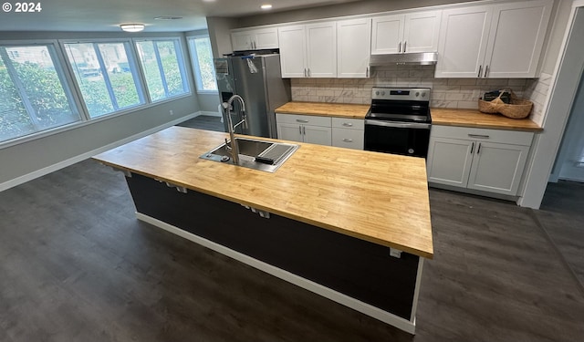 kitchen with butcher block counters, white cabinetry, sink, backsplash, and appliances with stainless steel finishes