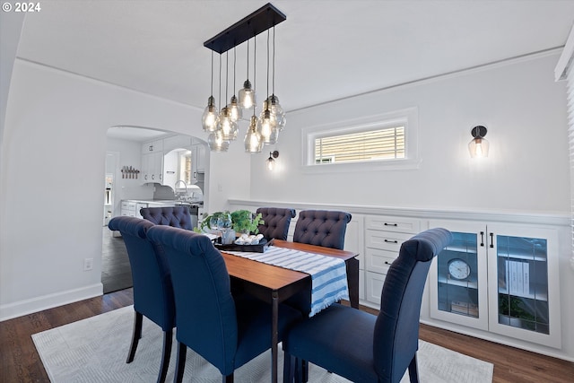 dining room with a notable chandelier and dark wood-type flooring