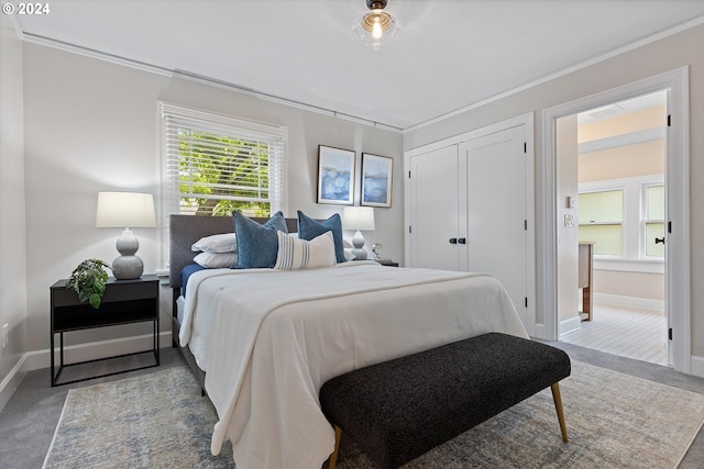 bedroom with ornamental molding and light colored carpet