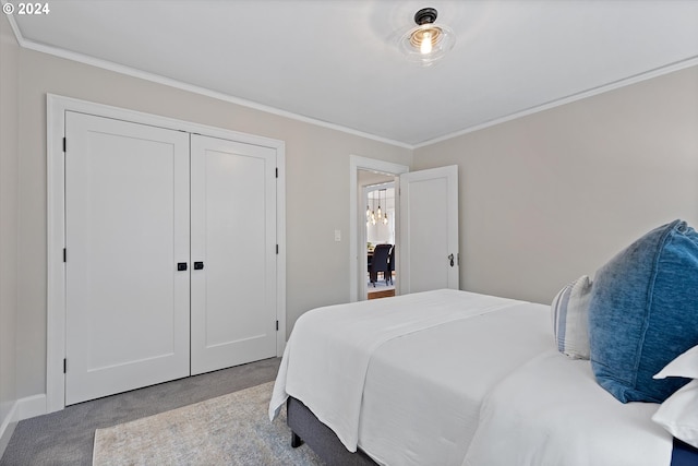 bedroom featuring ornamental molding, light carpet, and a closet