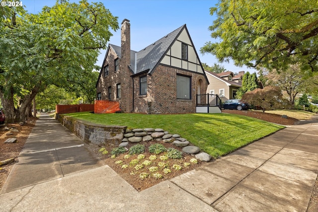 view of side of home with a yard