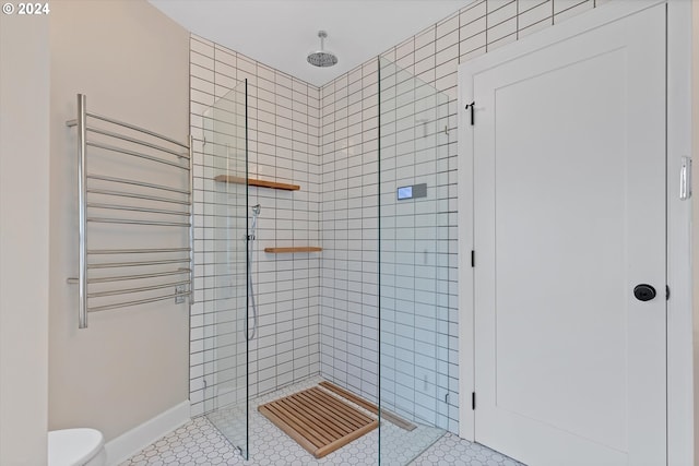 bathroom with a shower with door, radiator heating unit, toilet, and tile patterned flooring