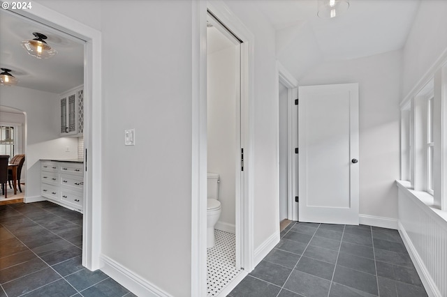 hallway with dark tile patterned floors