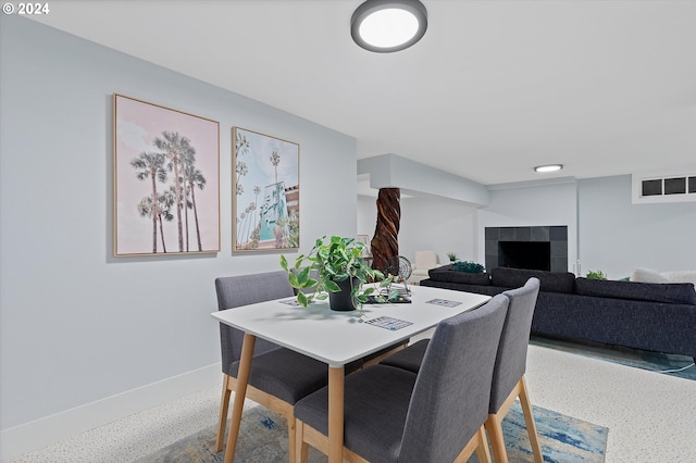 dining room featuring a tile fireplace