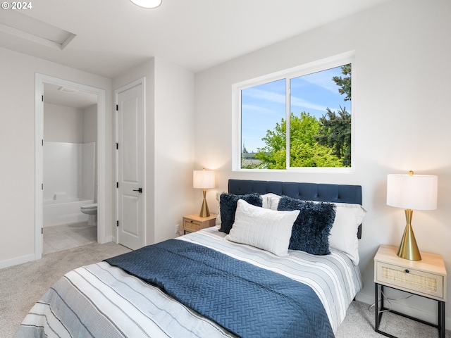 bedroom with light carpet and ensuite bathroom