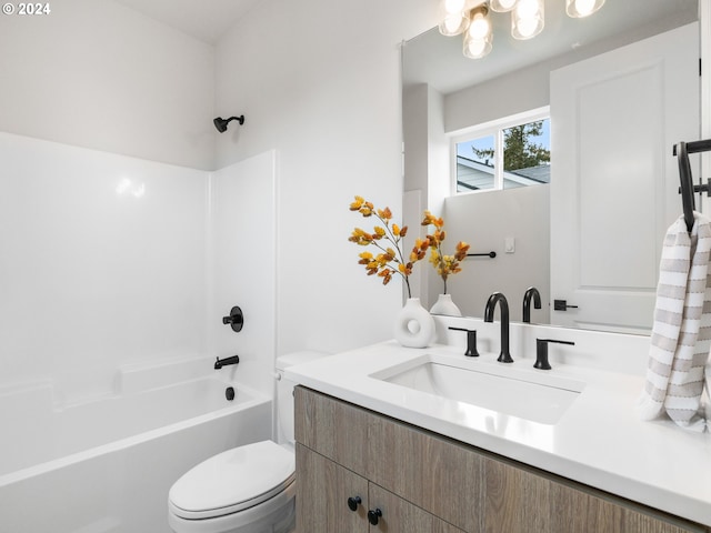 full bathroom with toilet, an inviting chandelier, washtub / shower combination, and large vanity