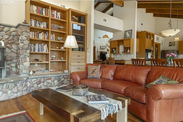 17252 N Applegate Rd, Grants Pass, OR 97527 - living room featuring a high ceiling, wood finished floors, beam ceiling, and a wood stove
