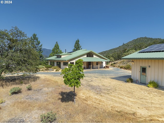 17252 N Applegate Rd, Grants Pass, OR 97527 - rear view of property featuring a mountain view, driveway, board and batten siding, and metal roof