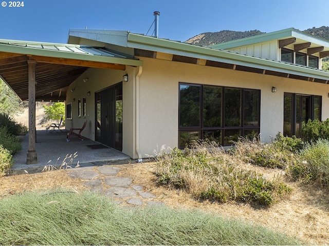 17252 N Applegate Rd, Grants Pass, OR 97527 - rear view of house with stucco siding, a patio, and board and batten siding