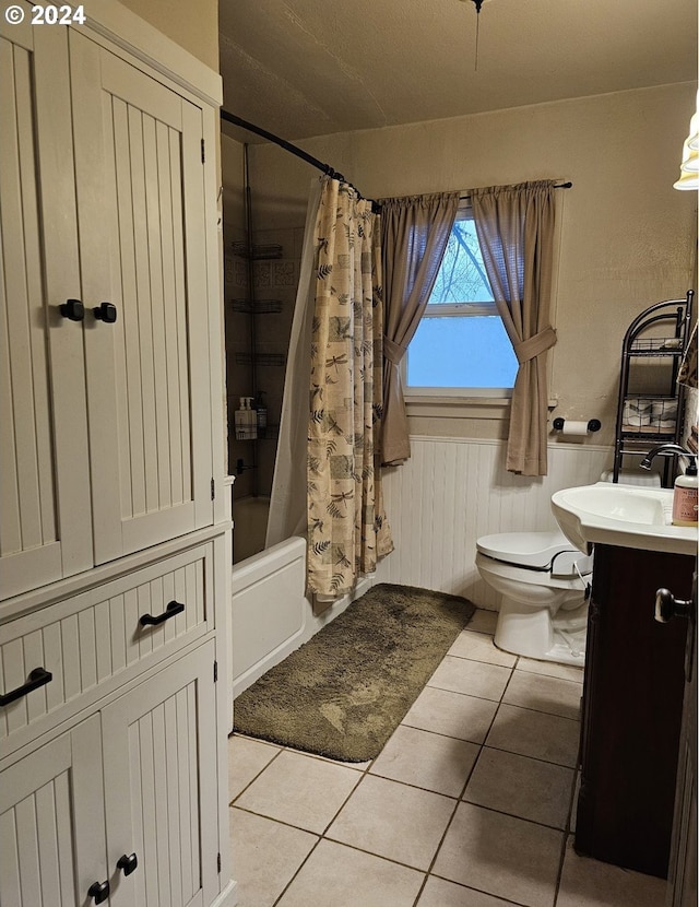 full bathroom featuring shower / bath combination with curtain, tile patterned floors, toilet, and vanity