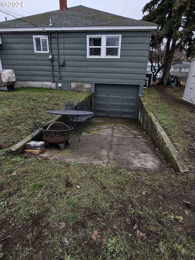 view of side of home featuring a fire pit