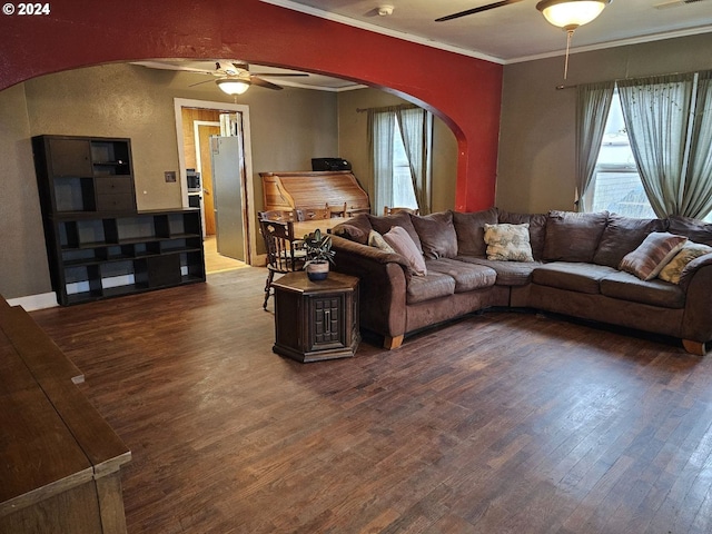 living room with a healthy amount of sunlight, crown molding, wood-type flooring, and ceiling fan