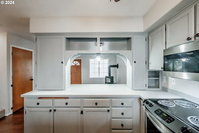 kitchen featuring appliances with stainless steel finishes, dark hardwood / wood-style floors, and white cabinets