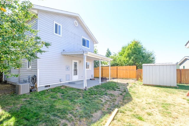 back of property featuring a patio area, a storage shed, a yard, and cooling unit