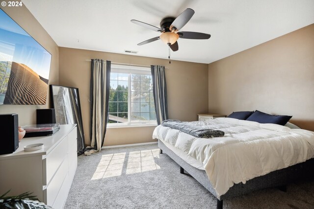 bedroom featuring ceiling fan and light colored carpet