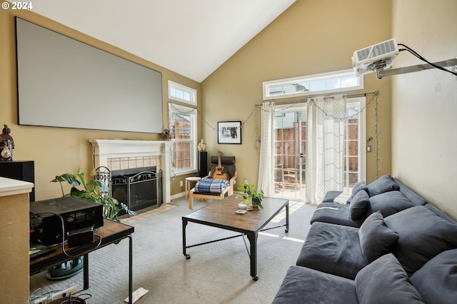 carpeted living room featuring high vaulted ceiling, plenty of natural light, and a tile fireplace