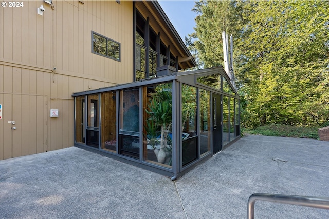 view of home's exterior featuring a patio area and a sunroom