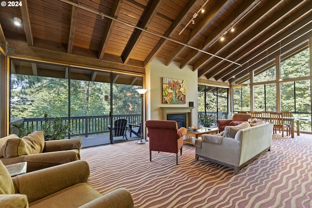 sunroom with lofted ceiling with beams, wood ceiling, and track lighting