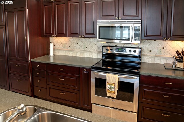225 S Montgomery St Unit G10, Portland, OR 97201 - kitchen with appliances with stainless steel finishes, tasteful backsplash, and dark countertops