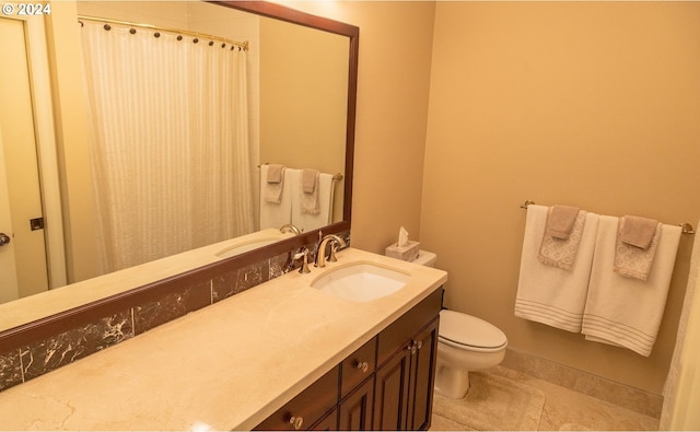 bathroom with tile patterned flooring, vanity, and toilet