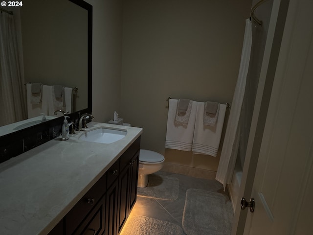 bathroom with tile patterned floors, vanity, and toilet