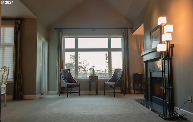 sitting room featuring carpet flooring and high vaulted ceiling