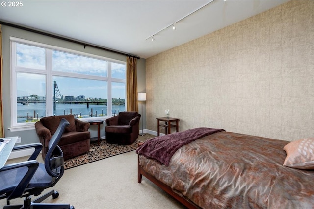 225 S Montgomery St Unit G10, Portland, OR 97201 - carpeted bedroom with a water view, rail lighting, and baseboards