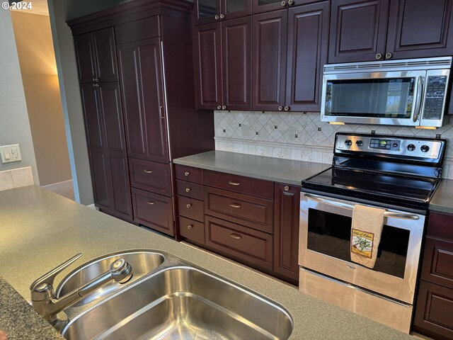 kitchen featuring decorative backsplash and appliances with stainless steel finishes