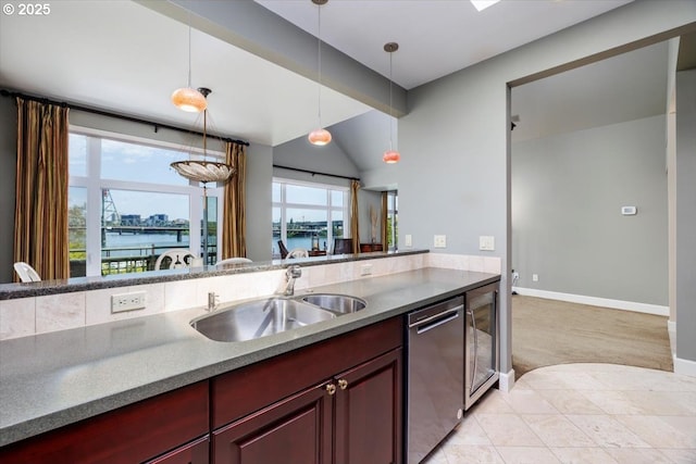 225 S Montgomery St Unit G10, Portland, OR 97201 - kitchen featuring stainless steel dishwasher, a sink, dark brown cabinets, a water view, and hanging light fixtures