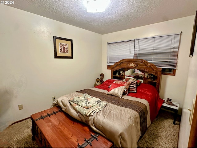 carpeted bedroom with a textured ceiling