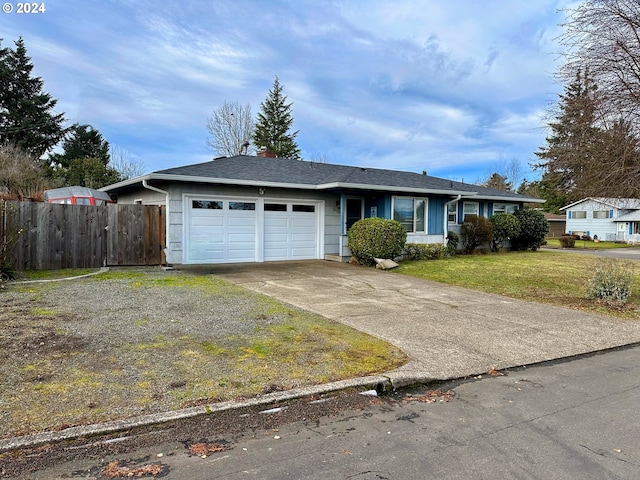 single story home featuring a front lawn, fence, concrete driveway, an attached garage, and a chimney