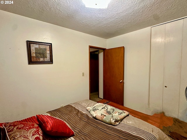 bedroom with a closet and a textured ceiling