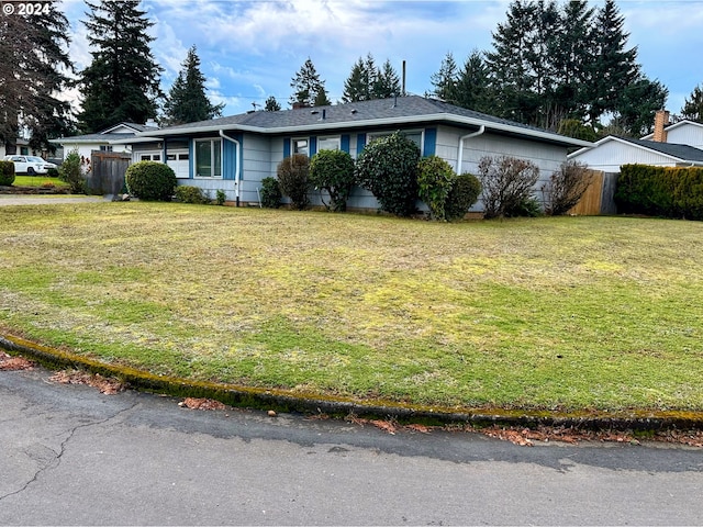 ranch-style house with a front lawn and fence