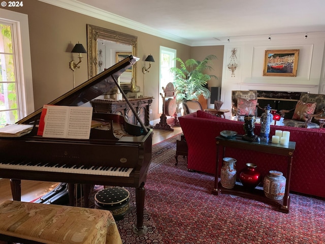 living area featuring a fireplace, crown molding, and wood-type flooring