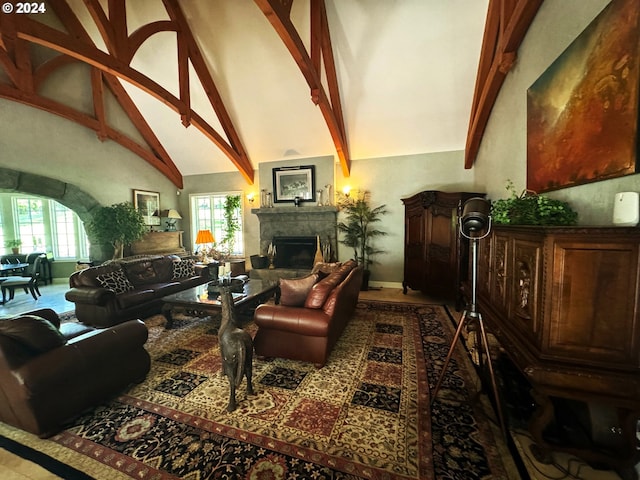 living room with beamed ceiling, high vaulted ceiling, and a healthy amount of sunlight