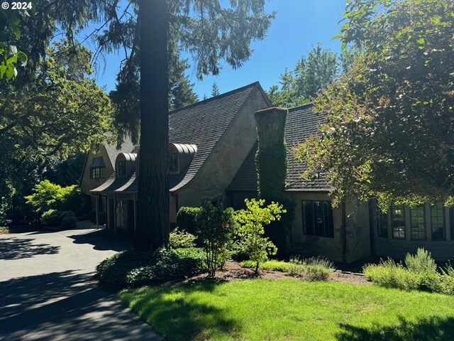 view of side of home featuring a yard