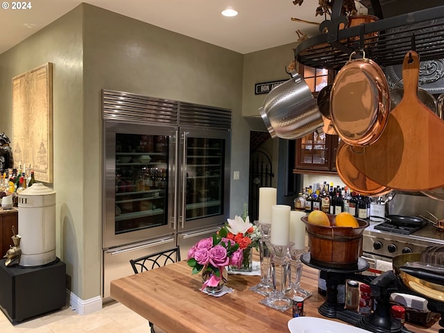 interior space with light tile patterned floors and wine cooler