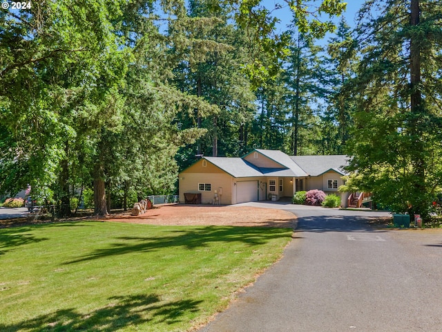 27580 SW Canyon Creek Rd, Wilsonville, OR 97070 - single story home featuring an attached garage, asphalt driveway, and a front lawn