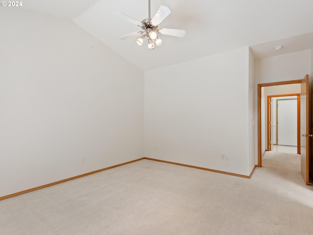 carpeted empty room with lofted ceiling and ceiling fan