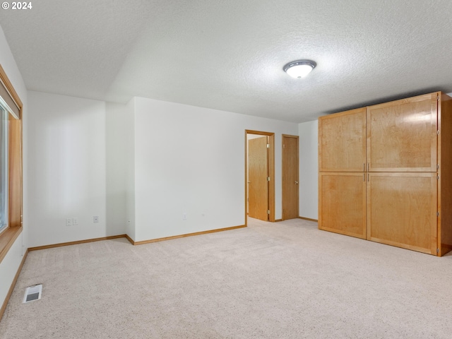 27580 SW Canyon Creek Rd, Wilsonville, OR 97070 - unfurnished bedroom featuring a textured ceiling, light carpet, and baseboards