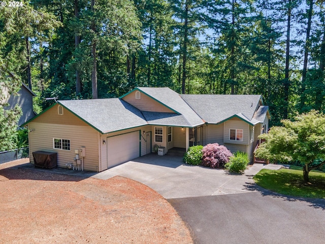 27580 SW Canyon Creek Rd, Wilsonville, OR 97070 - view of front of house with driveway, a garage, and a shingled roof