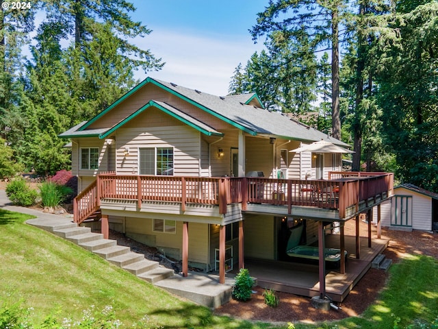 rear view of house with a wooden deck, a yard, and a shed