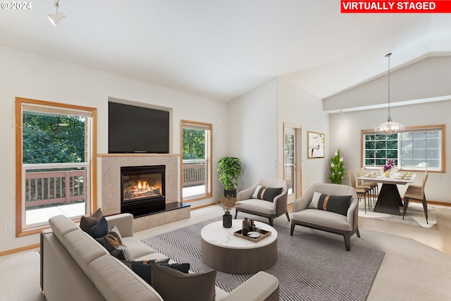 27580 SW Canyon Creek Rd, Wilsonville, OR 97070 - living area featuring vaulted ceiling, a high end fireplace, baseboards, a chandelier, and light carpet