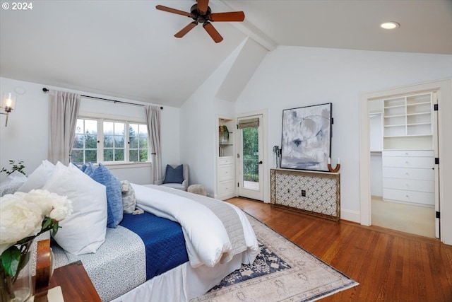 bedroom with access to outside, lofted ceiling with beams, a walk in closet, ceiling fan, and wood-type flooring