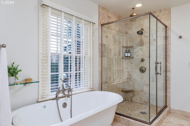 bathroom featuring tile patterned floors and separate shower and tub