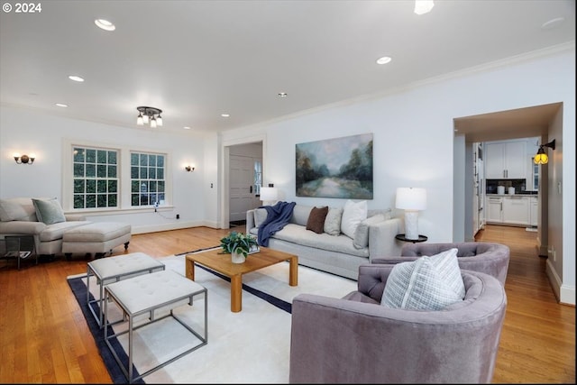 living room featuring light hardwood / wood-style flooring and ornamental molding