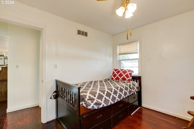 bedroom with ceiling fan and dark hardwood / wood-style flooring