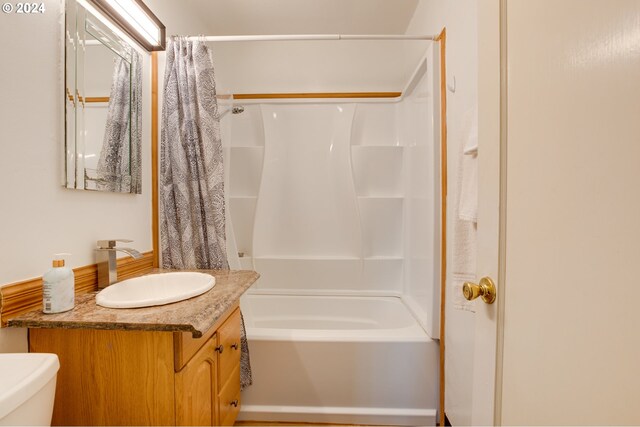 full bathroom featuring vanity, shower / tub combo, and toilet