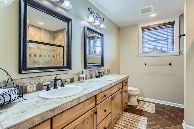 11529 SE Bateleur Way Unit C8, Happy Valley, OR 97086 - bathroom with tile patterned floors, double vanity, baseboards, and plenty of natural light